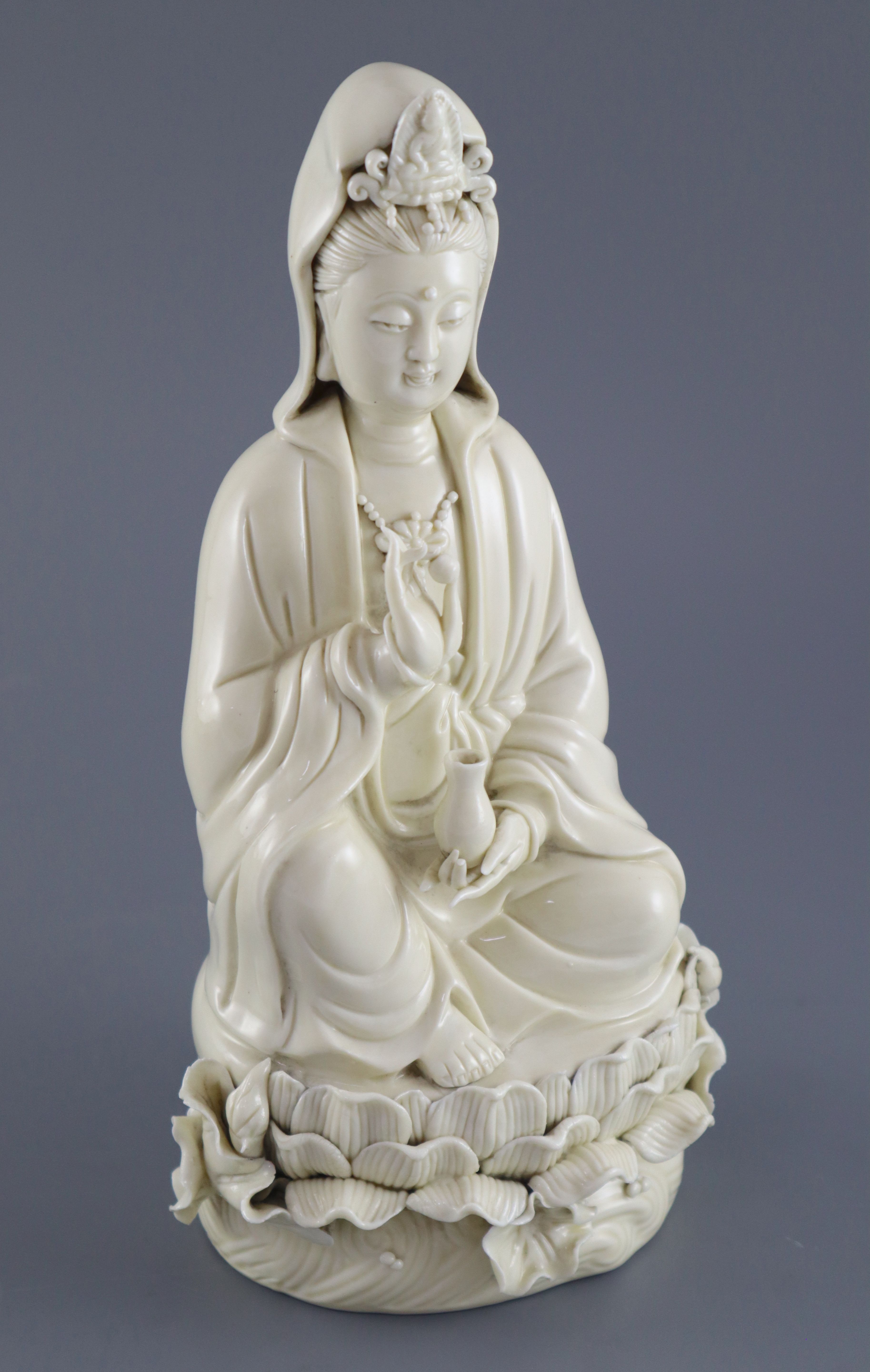A Chinese Dehua blanc de chine figure of Guanyin, impressed seal to back, 26.5cm high